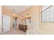 Well-lit bathroom featuring double vanity, tile floor, and a luxurious tub by a glass block window at 12018 Se 175Th Loop, Summerfield, FL 34491