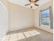 Cozy bedroom with a ceiling fan, closet, neutral carpet, and a window with natural light at 12018 Se 175Th Loop, Summerfield, FL 34491