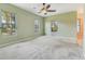 Large bedroom with light green walls, white trim and three windows for natural light at 12018 Se 175Th Loop, Summerfield, FL 34491