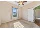 Bright, carpeted bedroom featuring a ceiling fan, natural light, and a closet at 12018 Se 175Th Loop, Summerfield, FL 34491