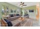 Staged living room with large windows providing natural light and neutral decor throughout at 12018 Se 175Th Loop, Summerfield, FL 34491