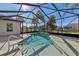 Enclosed swimming pool and spa with clear blue skies above at 12018 Se 175Th Loop, Summerfield, FL 34491