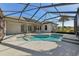 Bright pool area with a spa, all enclosed within a screened lanai and opening up to the backyard at 12018 Se 175Th Loop, Summerfield, FL 34491