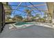 Screened-in pool area with a built-in spa, complemented by the view of palm trees at 12018 Se 175Th Loop, Summerfield, FL 34491