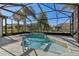 Clear view of a refreshing pool and spa within a screened-in enclosure, with bright, sunny scenery at 12018 Se 175Th Loop, Summerfield, FL 34491