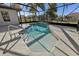 Sparkling pool and spa, all within a screened-in enclosure for ultimate comfort at 12018 Se 175Th Loop, Summerfield, FL 34491