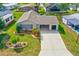 An aerial front view of the house, showcasing the landscaping, driveway, and well-maintained lawn at 1226 E Schwartz E Blvd, Lady Lake, FL 32159