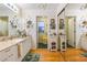 Well-lit bathroom with double vanity, mirrors, drawers, and wood-look floors at 1226 E Schwartz E Blvd, Lady Lake, FL 32159