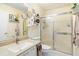 Bathroom with a modern vanity, frosted glass shower doors, and decorative shelving at 1226 E Schwartz E Blvd, Lady Lake, FL 32159