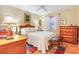 Bedroom featuring a wicker bed frame, a ceiling fan, and hardwood floors at 1226 E Schwartz E Blvd, Lady Lake, FL 32159