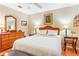 Inviting bedroom with a large bed, a ceiling fan, and wood-look floors at 1226 E Schwartz E Blvd, Lady Lake, FL 32159