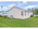 The exterior side view of a home showcasing the siding, windows, and a well-maintained lawn at 1226 E Schwartz E Blvd, Lady Lake, FL 32159