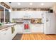 Well-lit kitchen features white cabinetry, modern appliances, and decorative accents above the cabinets at 1226 E Schwartz E Blvd, Lady Lake, FL 32159