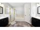 Bathroom featuring dual sink vanities, soaking tub and walk-in shower at 128 Calabria Springs Cv, Sanford, FL 32771