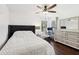 Cozy bedroom featuring a large bed, modern dresser and natural light from a nearby window at 128 Calabria Springs Cv, Sanford, FL 32771