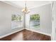 Dining room featuring a chandelier, hardwood floors, and natural light from the windows at 128 Calabria Springs Cv, Sanford, FL 32771