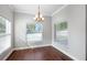 Dining area with a chandelier and large windows bringing in natural light at 128 Calabria Springs Cv, Sanford, FL 32771