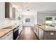 Modern kitchen featuring an island, stainless appliances, and white subway tile backsplash at 128 Calabria Springs Cv, Sanford, FL 32771