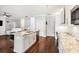 Bright kitchen island with seating and stainless steel appliances open to a living area at 128 Calabria Springs Cv, Sanford, FL 32771