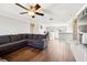 Living room featuring an expansive gray sectional sofa and wood floors at 128 Calabria Springs Cv, Sanford, FL 32771