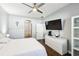 Main bedroom with a ceiling fan, a view of an ensuite bathroom, and wood-look floors at 128 Calabria Springs Cv, Sanford, FL 32771