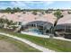 A high angle view of beautiful homes with tile roofs, well manicured landscaping, and screened pools at 13336 Lake Turnberry Cir, Orlando, FL 32828