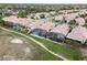 Expansive view showcasing homes with tile roofs, screened pools, and lush greenery, situated in a desirable neighborhood at 13336 Lake Turnberry Cir, Orlando, FL 32828