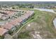 An aerial view of a subdivision home near a scenic path and waterfront featuring a terracotta roof at 13336 Lake Turnberry Cir, Orlando, FL 32828