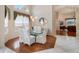 Elegant dining room with a glass table, white chairs, and a large window at 13336 Lake Turnberry Cir, Orlando, FL 32828