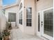 Charming front porch area featuring stylish tiled flooring, an exterior door, and ample natural light at 13336 Lake Turnberry Cir, Orlando, FL 32828