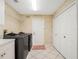 Laundry room with washer, dryer, cabinets, closet, and tile flooring at 13336 Lake Turnberry Cir, Orlando, FL 32828