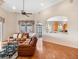 Comfortable living room with a leather sectional sofa and a view into the kitchen at 13336 Lake Turnberry Cir, Orlando, FL 32828