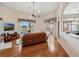 Bright living room with wood floors, large windows overlooking the pool, and a leather sofa at 13336 Lake Turnberry Cir, Orlando, FL 32828