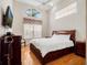 This main bedroom features a large window, ceiling fan, wood floors, and a king-size bed at 13336 Lake Turnberry Cir, Orlando, FL 32828