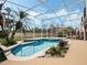 Outdoor pool with spa, screened lanai, and tropical landscaping at 13336 Lake Turnberry Cir, Orlando, FL 32828