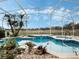 Outdoor pool with spa, screened lanai, and decorative plants at 13336 Lake Turnberry Cir, Orlando, FL 32828