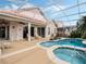 The screened in pool and spa are surrounded by a light colored deck, perfect for entertaining and relaxation at 13336 Lake Turnberry Cir, Orlando, FL 32828