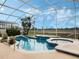 Outdoor pool with screened lanai, spa, and view at 13336 Lake Turnberry Cir, Orlando, FL 32828