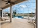 Outdoor pool with a screened enclosure, spa, patio and lush landscape at 13336 Lake Turnberry Cir, Orlando, FL 32828