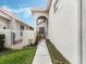 Side entrance featuring a serene walkway leading to the home with a secure gated entrance at 13336 Lake Turnberry Cir, Orlando, FL 32828