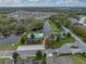 Aerial view of community, showcasing amenities: pool, playground, and pond at 1385 Evergreen Park Cir, Lakeland, FL 33813