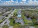 Panoramic aerial view of a community with lake, pool, playground, and homes at 1385 Evergreen Park Cir, Lakeland, FL 33813