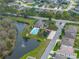 Aerial view of a community with a pond, swimming pool and playground at 1385 Evergreen Park Cir, Lakeland, FL 33813