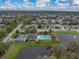 Aerial view of community with a pool and playground near a pond and with many beautiful homes surrounding at 1385 Evergreen Park Cir, Lakeland, FL 33813