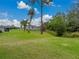 Expansive backyard with a serene pond view, offering a tranquil retreat amidst lush greenery at 1385 Evergreen Park Cir, Lakeland, FL 33813