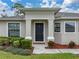 Close-up view of the front entrance with a decorative door, manicured landscaping, and a welcoming atmosphere at 1385 Evergreen Park Cir, Lakeland, FL 33813