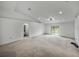 Large living room featuring carpet floors, neutral walls, and sliding glass door to backyard at 1385 Evergreen Park Cir, Lakeland, FL 33813