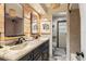 Bathroom with dual sinks, wood accent wall, stylish mirror, and clean lines at 142 Habersham Dr, Longwood, FL 32779