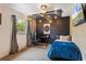 Bedroom with exposed metal ceiling, brick accent wall, and dark color palette at 142 Habersham Dr, Longwood, FL 32779