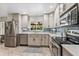 Bright kitchen featuring stainless steel appliances, light cabinets, and window overlooking backyard at 142 Habersham Dr, Longwood, FL 32779